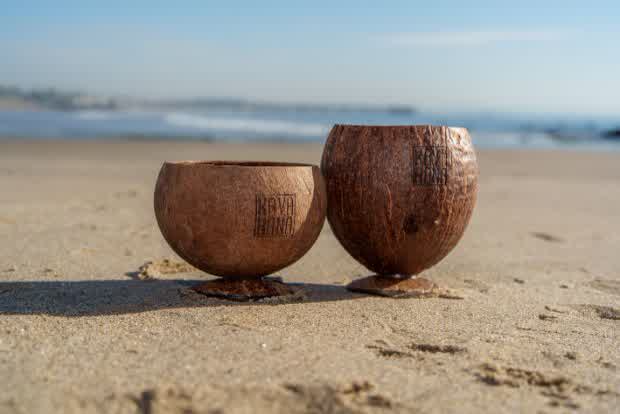 Two Kavahana coconut shell cups on the beach